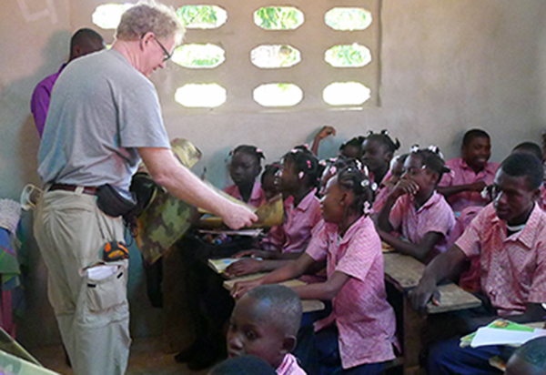 Durham professor James Goedert interacts with students in the new Flower of Hope School building.